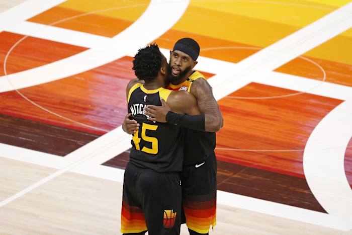 Donovan Mitchell (45) and Royce O'Neale (23) embrace at mid-court